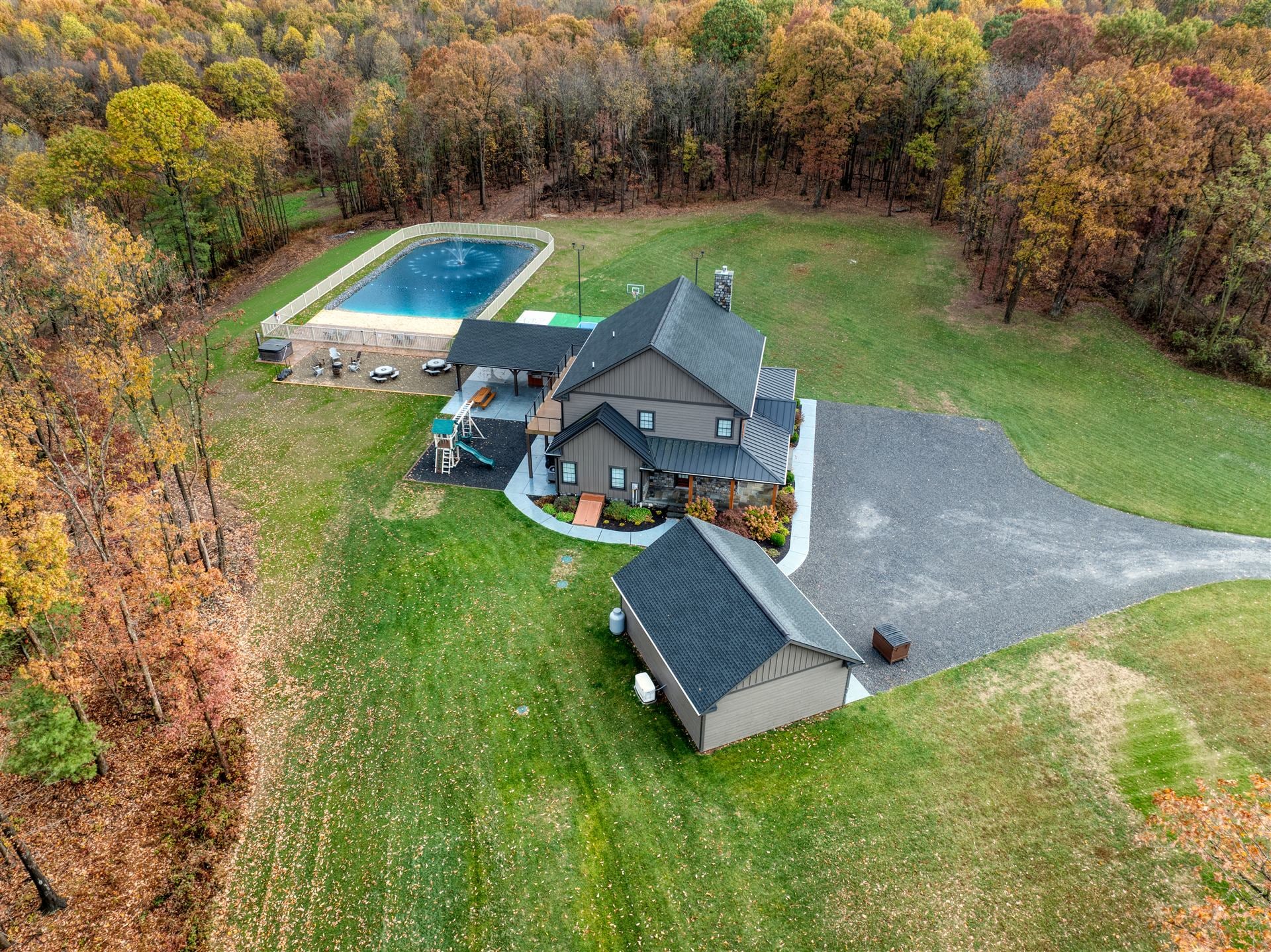 Aerial view of the property and pond